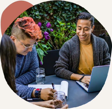 team members collaborating on a desk outdoors